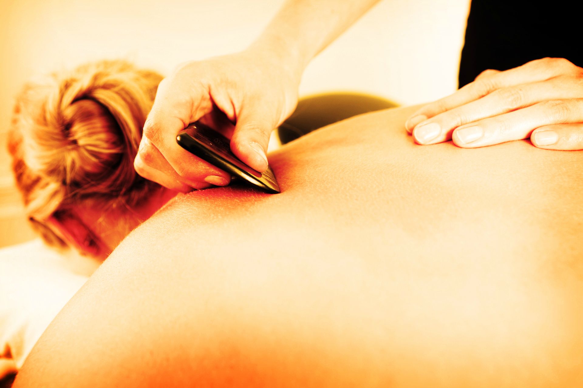 gua sha uses the scraping of the skin to release toxins and promote healing